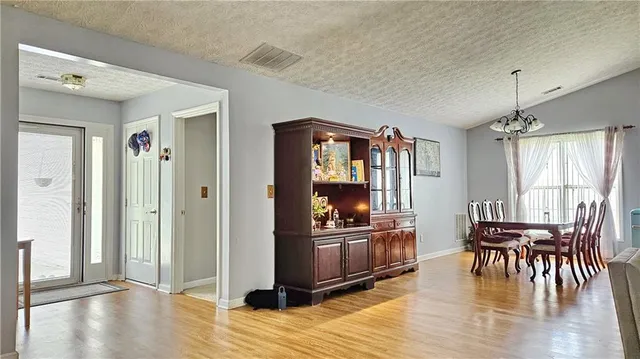 a view of a livingroom with furniture hardwood floor and a flat screen tv