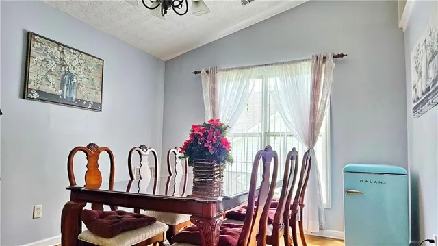 a view of a dining room with furniture and window