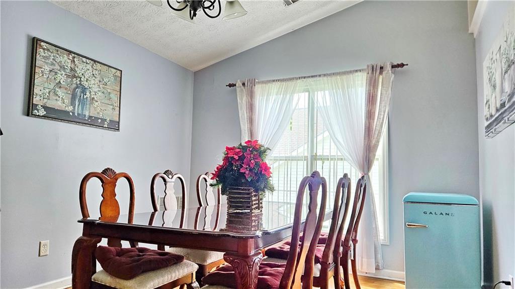 2233 Hansford Pass Buford, GA 30519 - Photo 22 of 45 a view of a dining room with furniture and window