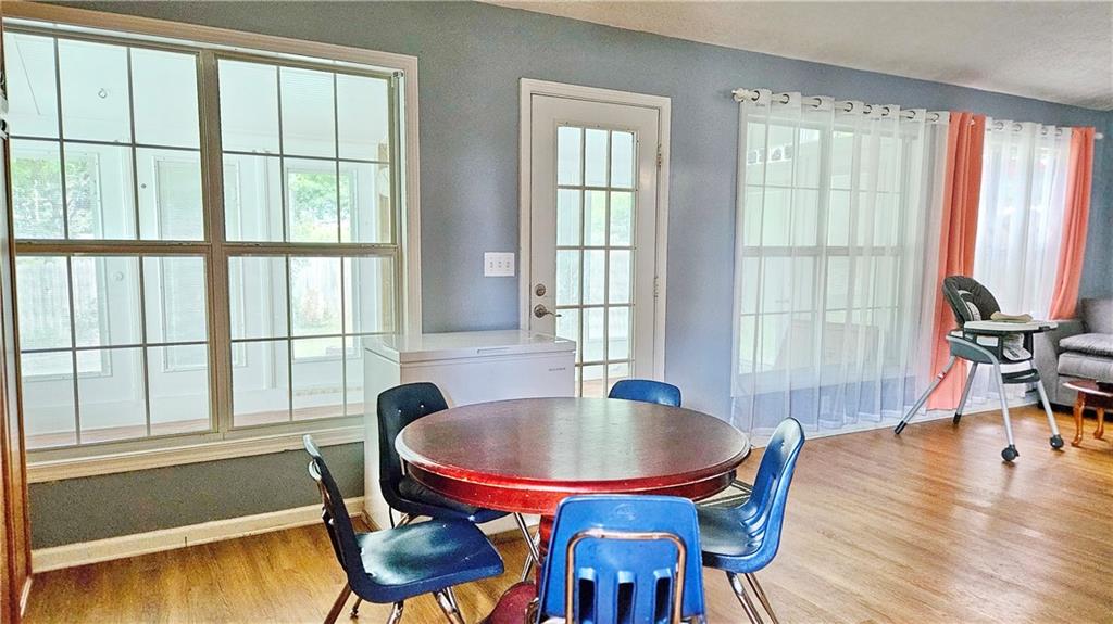 2233 Hansford Pass Buford, GA 30519 - Photo 24 of 45 a view of a dining room with furniture window and wooden floor
