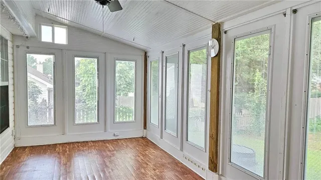 a view of an entrance with wooden floor and windows