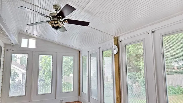 a view of a room with a window and a ceiling fan