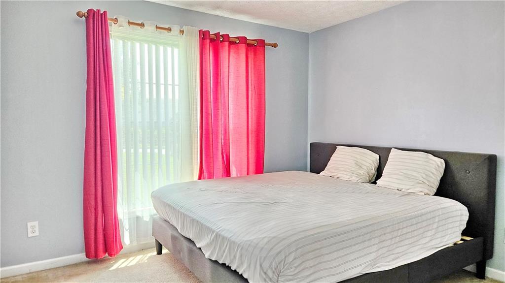 2233 Hansford Pass Buford, GA 30519 - Photo 30 of 45 a bedroom with a bed and a window