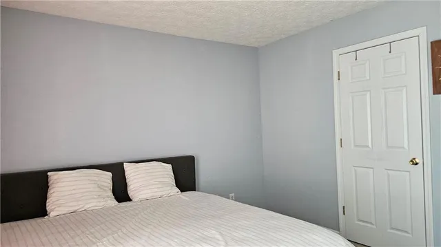 a bedroom with a bed and curtain