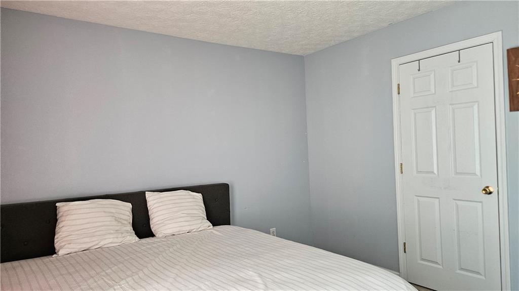 2233 Hansford Pass Buford, GA 30519 - Photo 31 of 45 a bedroom with a bed and curtain