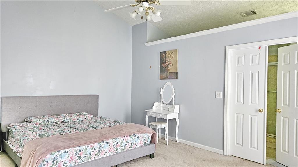 2233 Hansford Pass Buford, GA 30519 - Photo 32 of 45 a bedroom with a bed and a chandelier