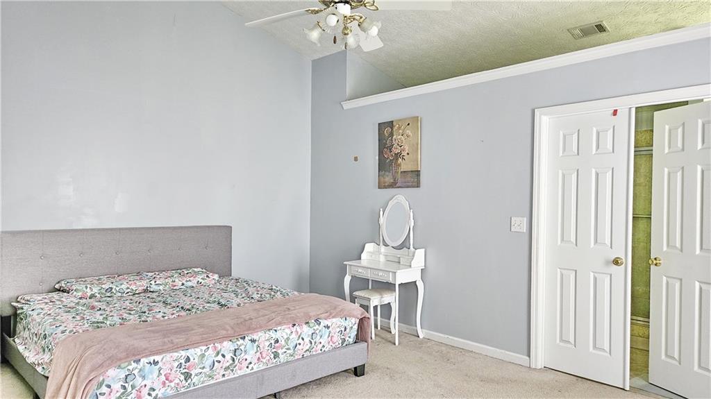 2233 Hansford Pass Buford, GA 30519 - Photo 33 of 45 a bedroom with a bed and a chandelier