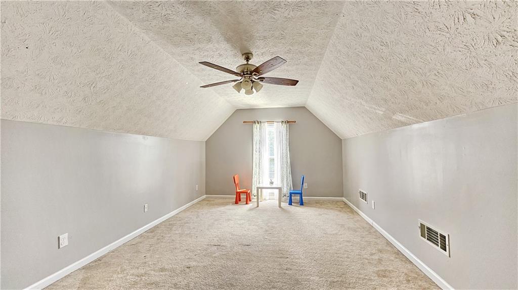 2233 Hansford Pass Buford, GA 30519 - Photo 40 of 45 an empty room with chandelier fan and windows