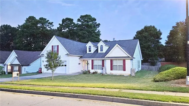 a front view of a house with swimming pool having outdoor seating