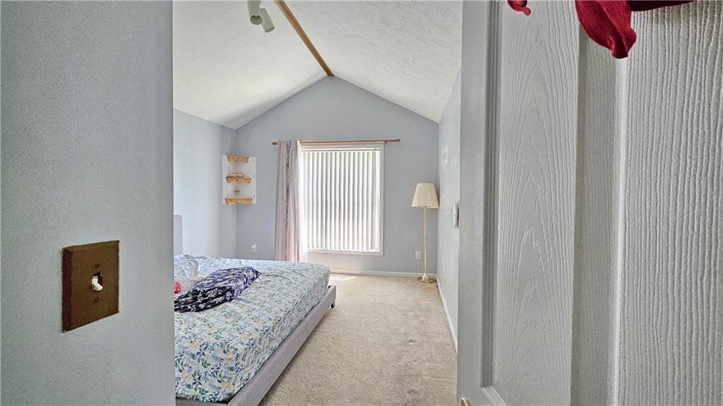 2233 Hansford Pass Buford, GA 30519 - Photo 43 of 45 a bedroom with a bed and a chandelier