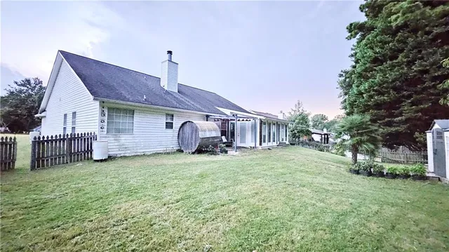 a backyard of a house with table and chairs