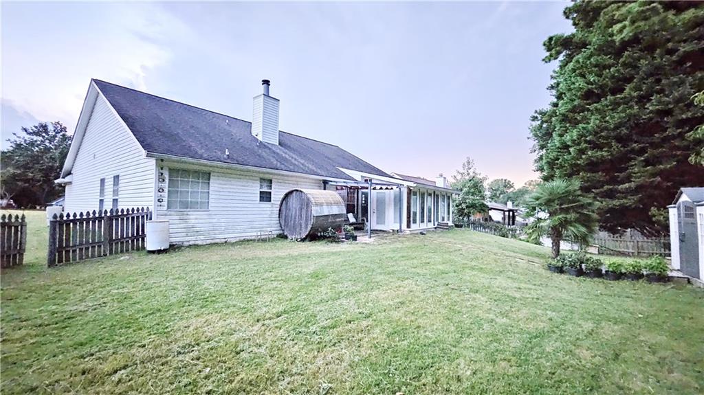 2233 Hansford Pass Buford, GA 30519 - Photo 9 of 45 a backyard of a house with table and chairs