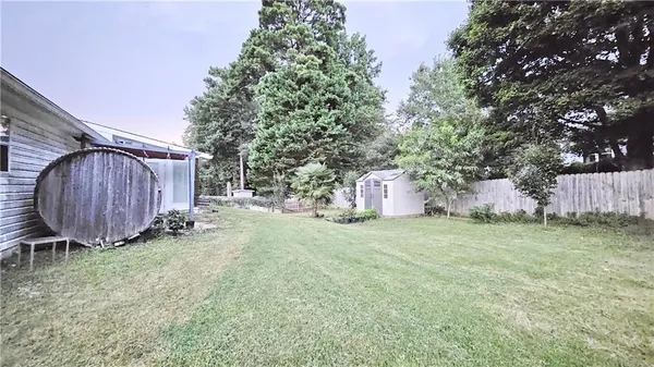 a backyard of a house with a yard and outdoor seating