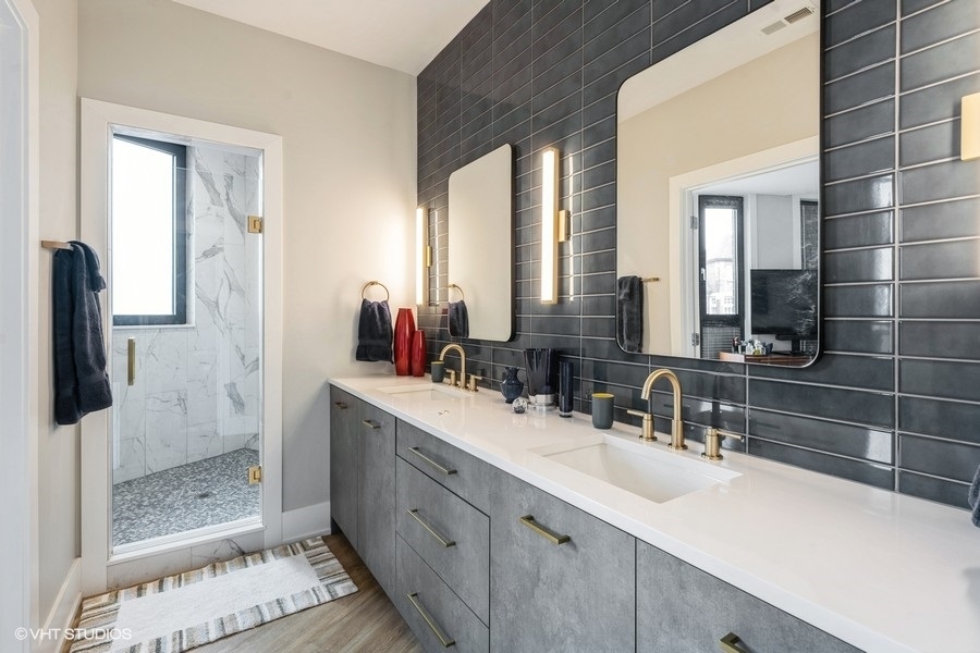 3839 North Clark Street, Unit 105 Chicago, IL 60613 - Photo 6 of 7 a bathroom with a double vanity sink mirror and shower