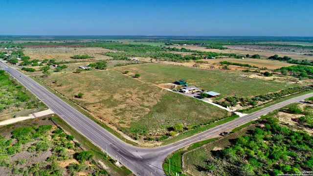 a view of a house with staircase and wooden fence