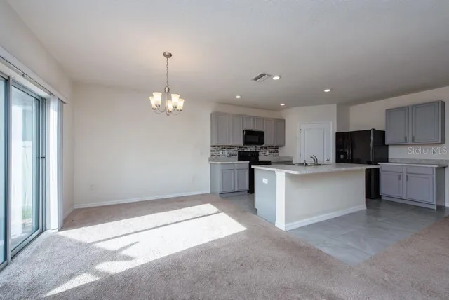 a kitchen with kitchen island a sink stainless steel appliances and cabinets