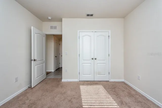 a view of a bedroom with closet area