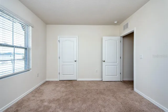 a view of a chairs and table on the patio