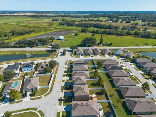 an aerial view of residential building and lake