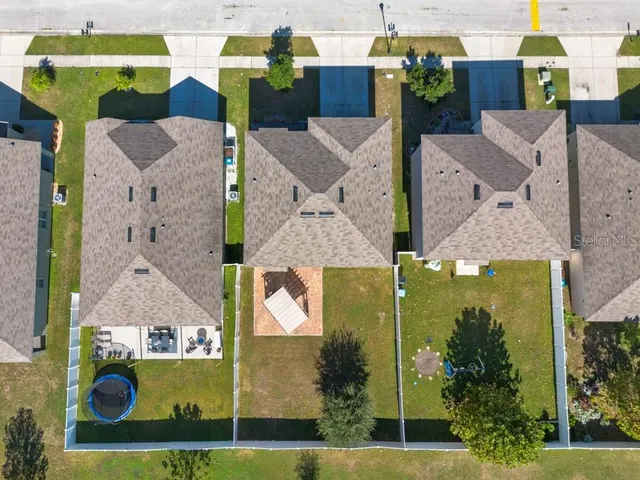 an aerial view of a house with a swimming pool