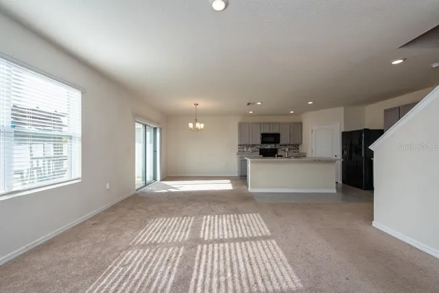 a view of a kitchen with a sink and dishwasher a refrigerator with wooden floor