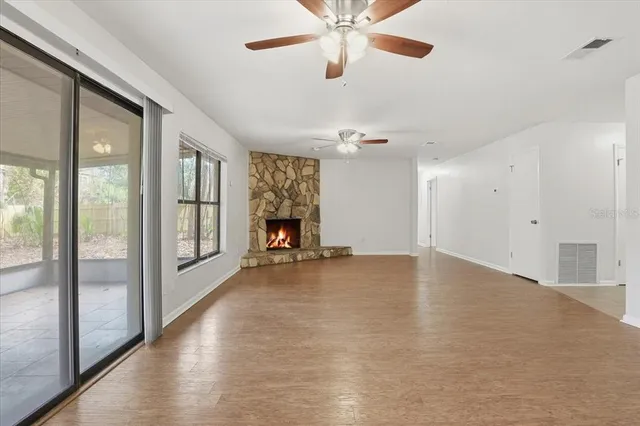a view of an empty room with glass door and a window