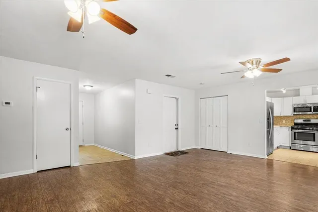 a view of a livingroom with a ceiling fan and window