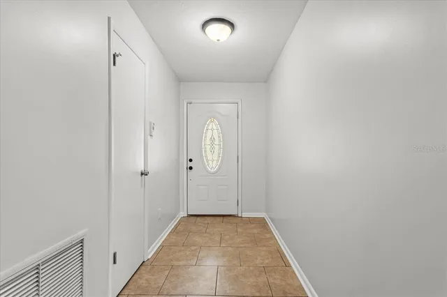 an empty room with entrance and mirror