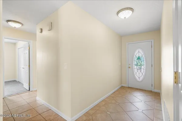 a view of an entryway with wooden floor and door