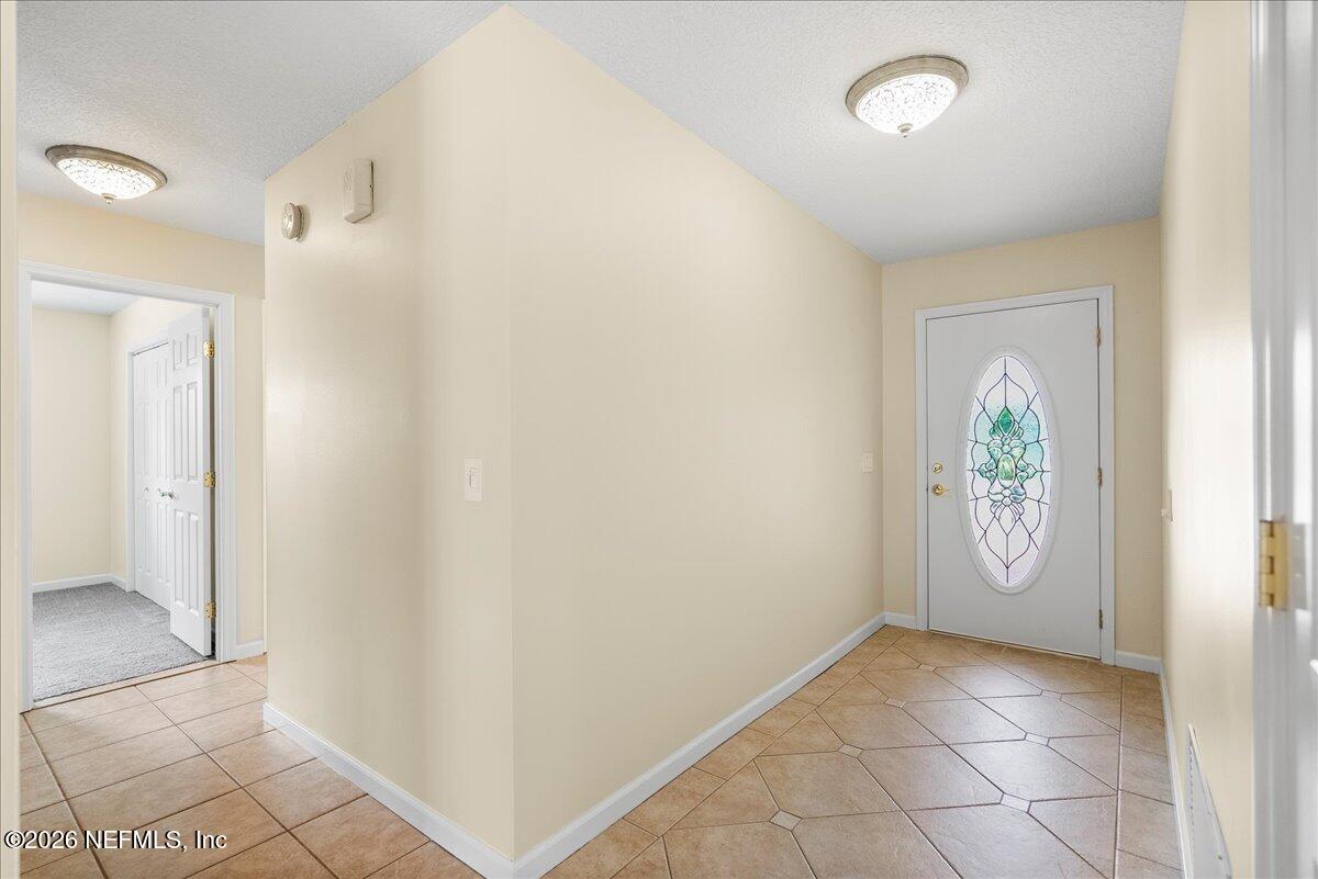 4201 San Pablo Road South Jacksonville, FL 32250 - Photo 11 of 50 a view of an entryway with wooden floor and door