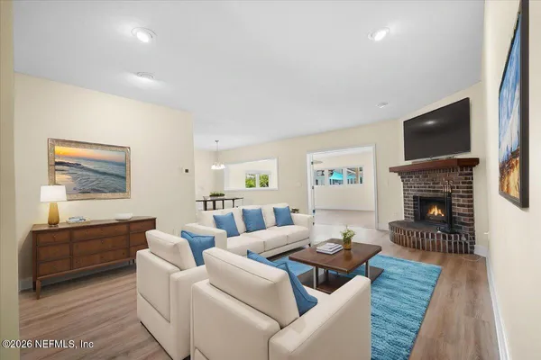 a living room with fireplace furniture and a flat screen tv