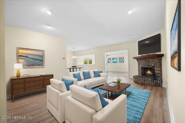 a living room with fireplace furniture and a flat screen tv