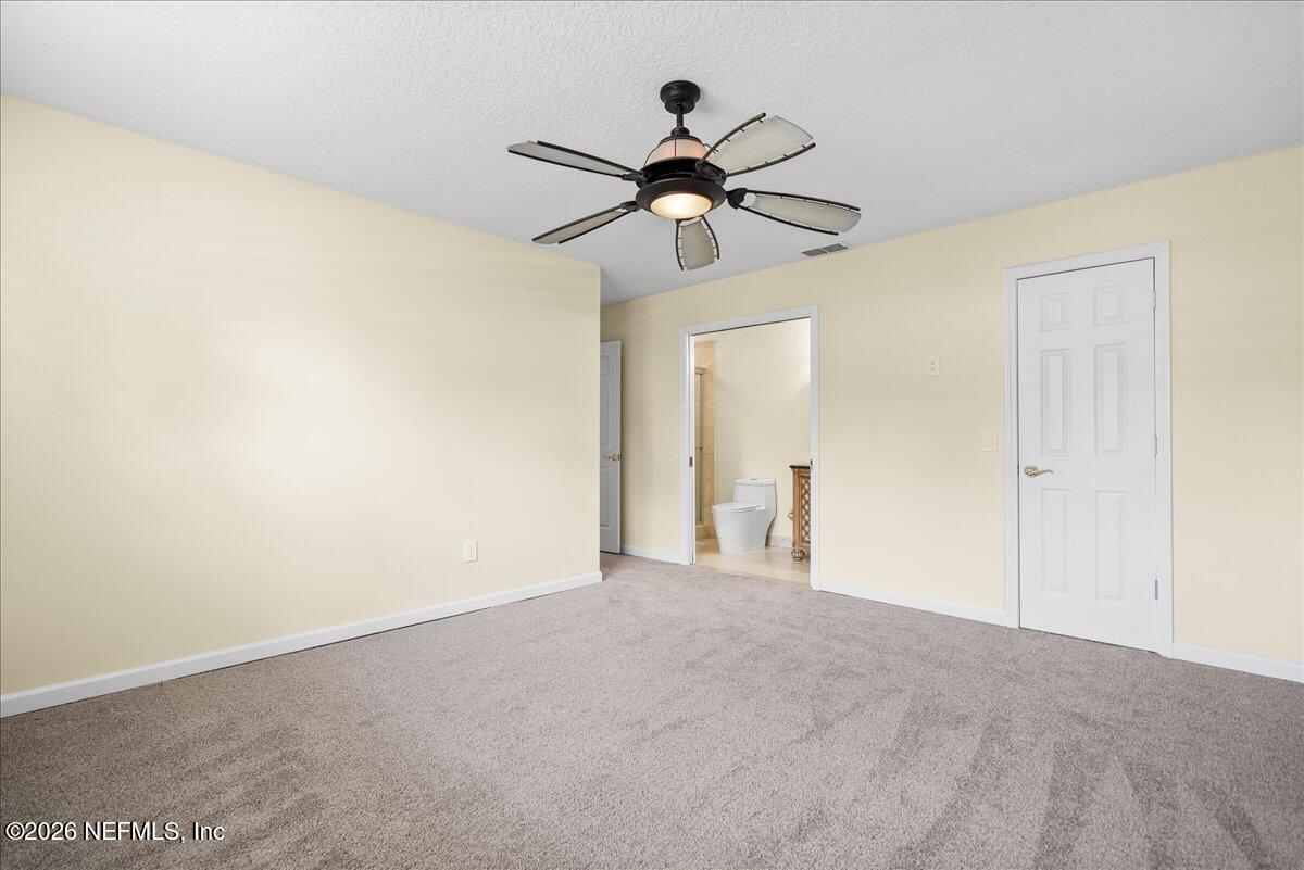4201 San Pablo Road South Jacksonville, FL 32250 - Photo 17 of 50 a view of empty room with a fan and a ceiling fan