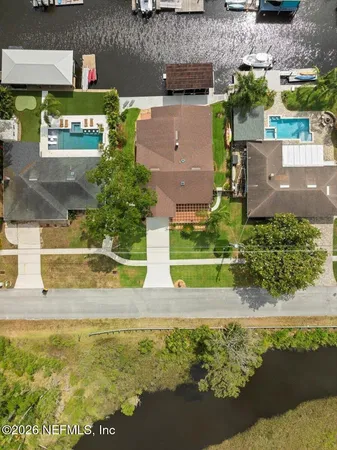an aerial view of a house with a yard
