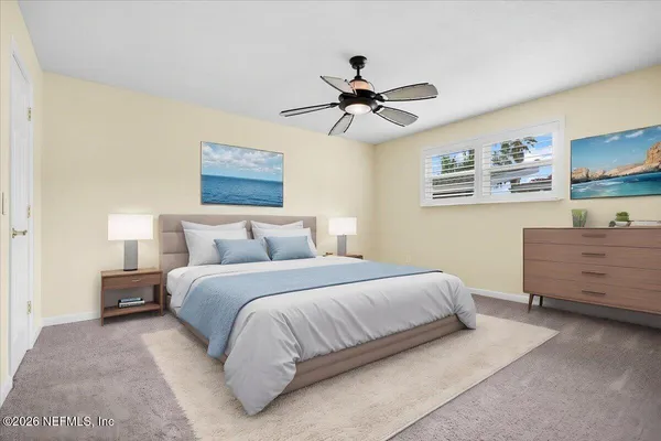 a bedroom with a bed and painting on the wall