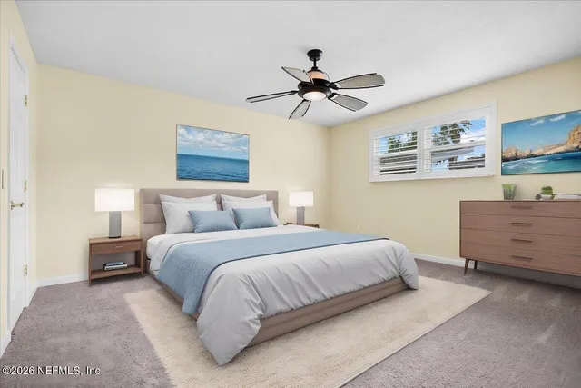 a bedroom with a bed and painting on the wall