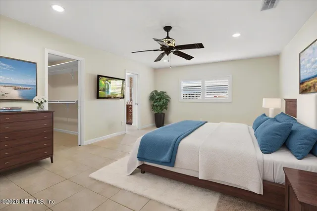 a bedroom with a bed and ceiling fan