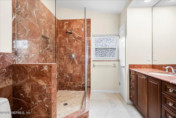 a bathroom with a shower and a sink