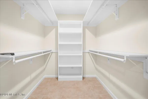 a view of walk in closet with empty racks