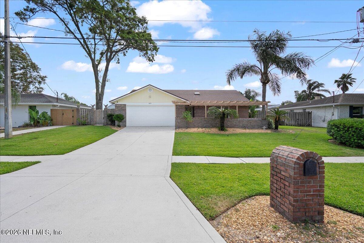 4201 San Pablo Road South Jacksonville, FL 32250 - Photo 3 of 50 a front view of a house with garden
