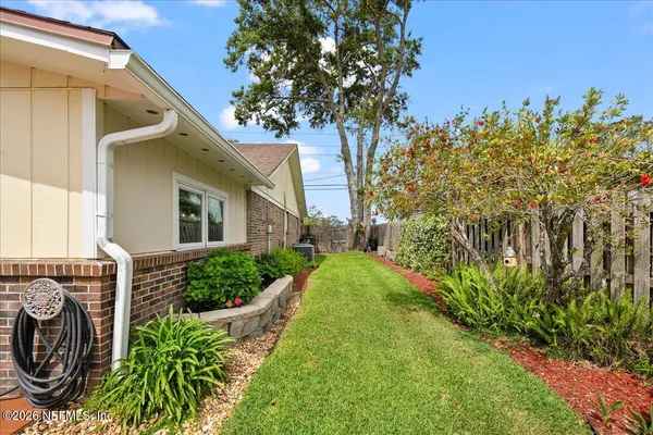 a view of a house with a flower garden