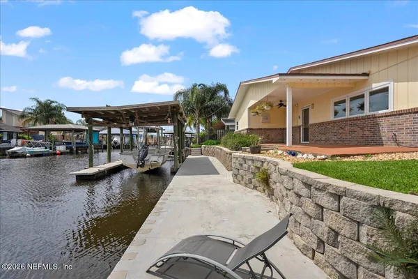 a view of swimming pool with outdoor seating and lake view