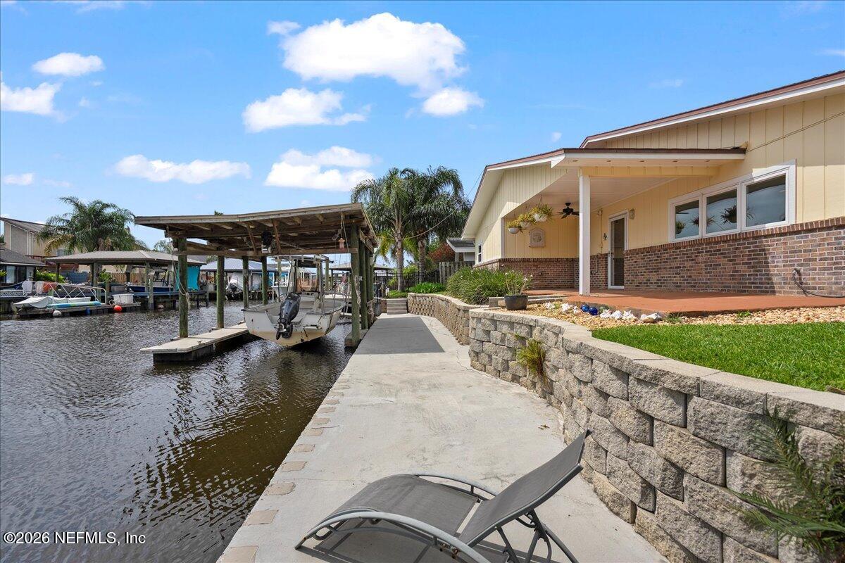 4201 San Pablo Road South Jacksonville, FL 32250 - Photo 38 of 50 a view of swimming pool with outdoor seating and lake view