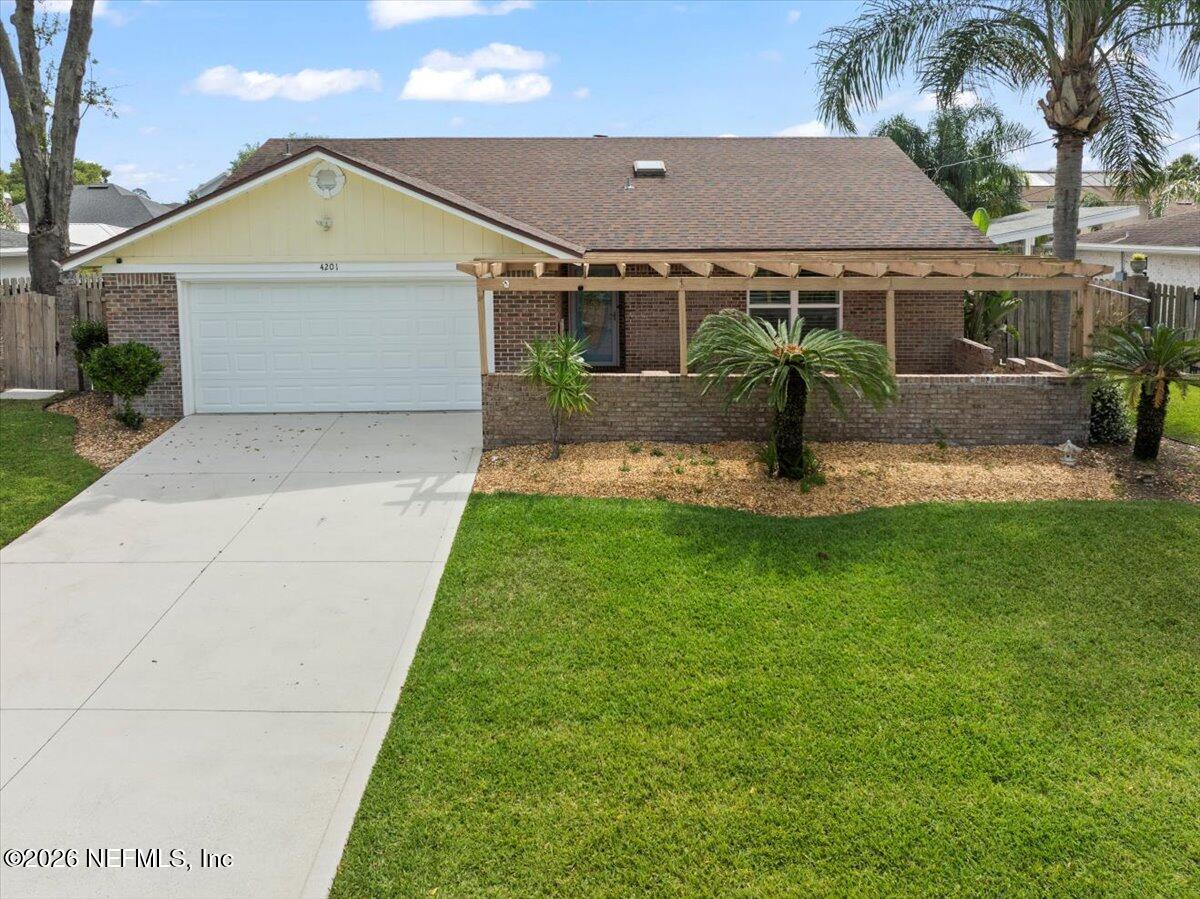 4201 San Pablo Road South Jacksonville, FL 32250 - Photo 4 of 50 a front view of a house with a yard and garage