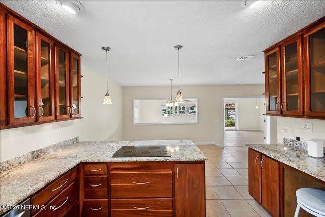 a kitchen with stainless steel appliances granite countertop a sink stove and cabinets