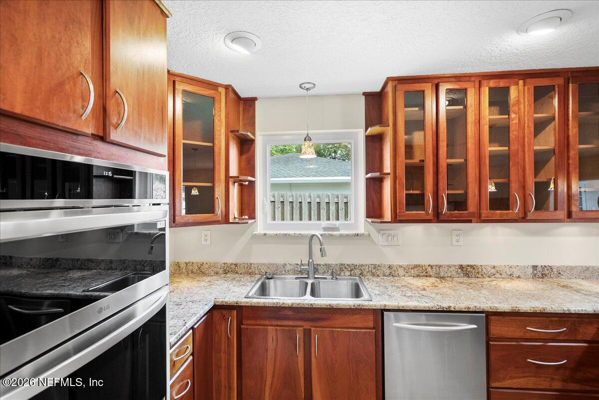 4201 San Pablo Road South Jacksonville, FL 32250 - Photo 9 of 50 a kitchen with granite countertop a stove and a sink