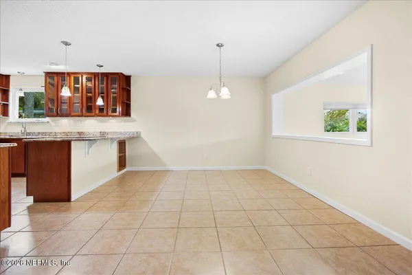 a view of kitchen with granite countertop cabinets next to a window