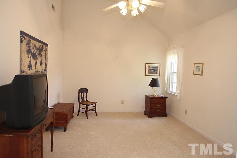 4901 Kinross Court Raleigh, NC 27613 - Photo 16 of 18 a living room with furniture and a flat screen tv
