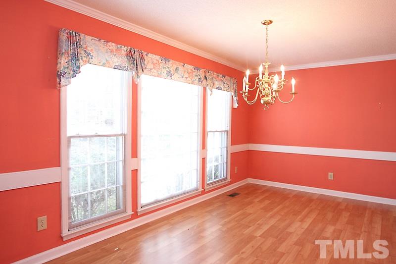 4901 Kinross Court Raleigh, NC 27613 - Photo 4 of 18 a view of empty room with wooden floor and fan