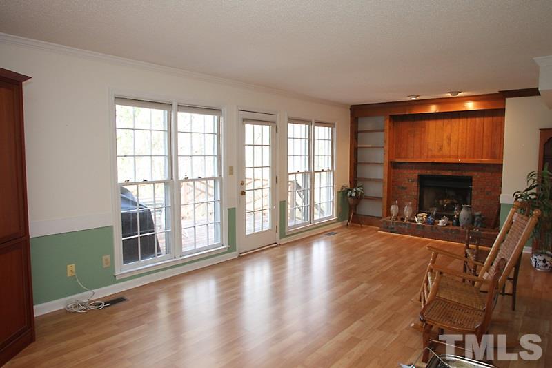 4901 Kinross Court Raleigh, NC 27613 - Photo 5 of 18 wooden floor in an empty room with a fireplace